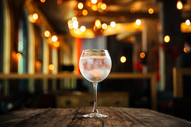 Fresh cool cocktail gin tonic on the wooden table