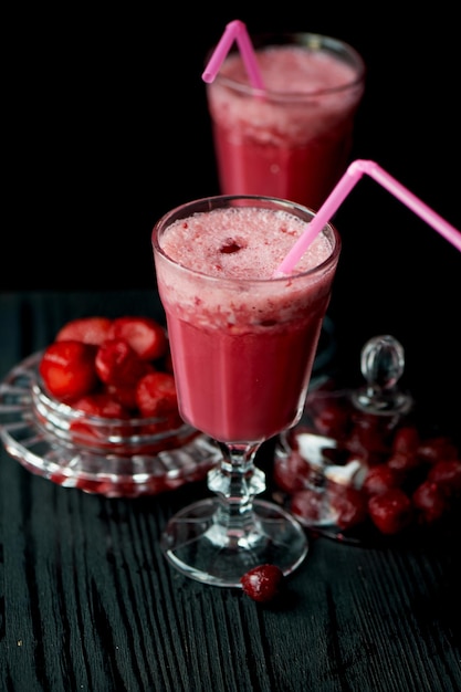 Fresh cool smoothie in a glass with a stem Delicious and healthy BreakfastOf cherries and strawberries