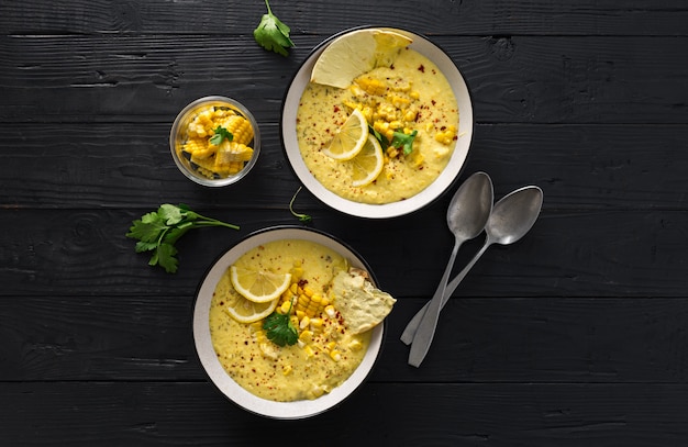 Fresh corn cream soup on a dark table