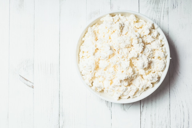 Fresh cottage cheese in bowl on the table