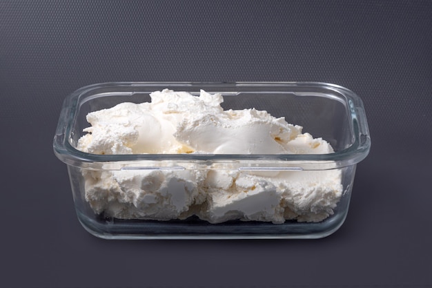 Fresh cottage cheese in glass container - curd isolated