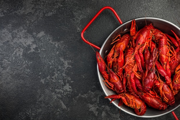 Fresh Crayfish in Soucepan on Dark Background