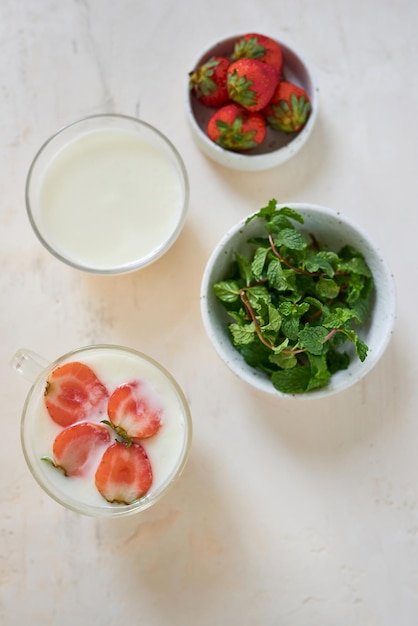 Fresh cream dessert with raw organic strawberry on white board French style yogurt