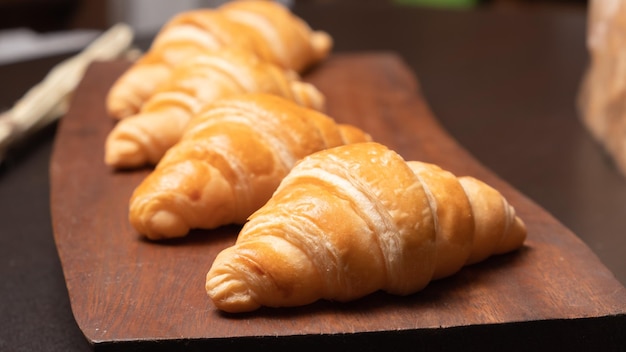 Fresh croissants on a wooden board Fresh bakery croissantsselective focus