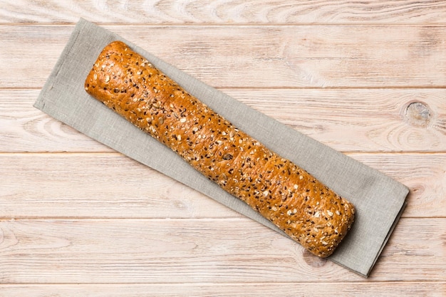 Fresh crunchy french baguette on colored table Top view Bakery products