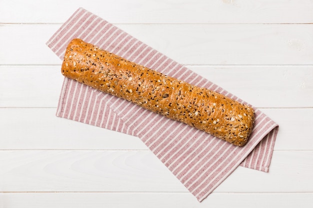 Fresh crunchy french baguette on colored table Top view Bakery products