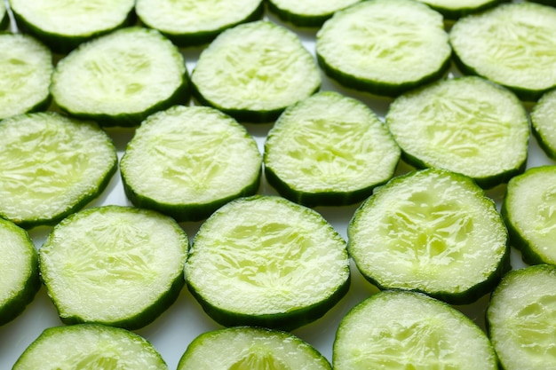 Fresh cucumber slices as background