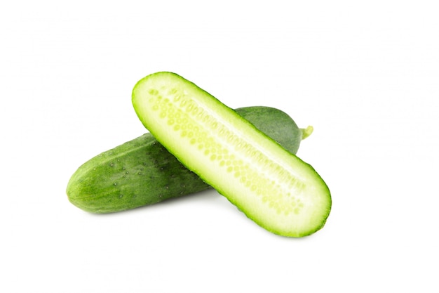 Fresh cucumber and slices isolated over white background.