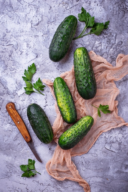 Fresh cucumbers on concrete background