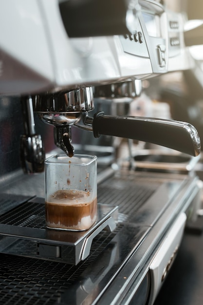 fresh cup of coffee on coffee machine