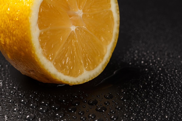 Fresh cut lemon on a black background