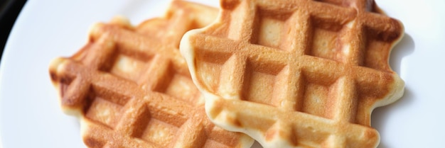 Fresh delicious homemade waffles on white plate