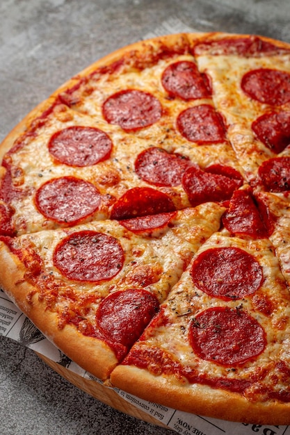 Fresh delicious Italian pizza on a gray stone table background