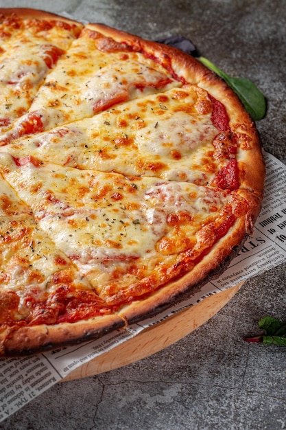 Fresh delicious Italian pizza on a gray stone table background