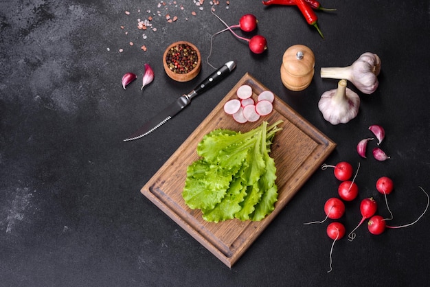 Fresh delicious lettuce leaves on a brown wooden cutting board