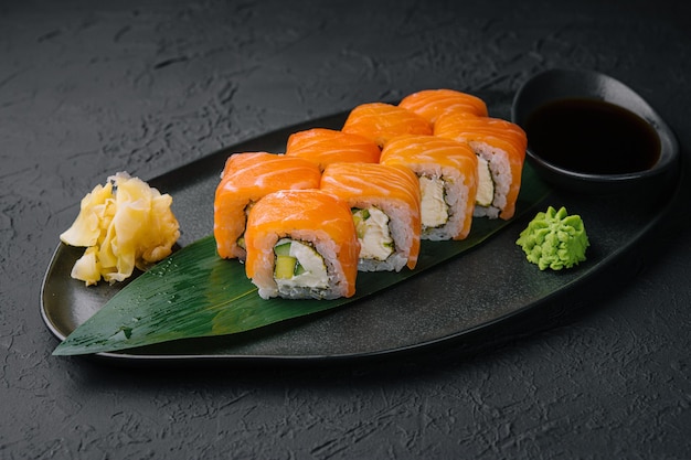 Fresh delicious philadelphia sushi on black plate