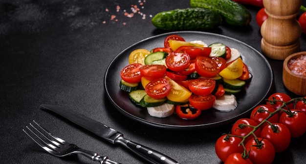 Fresh delicious salad with cherry tomatoes cucumbers sweet peppers cheese and olive oil