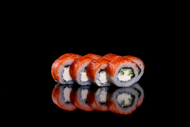 Fresh delicious sushi rolls on a dark background