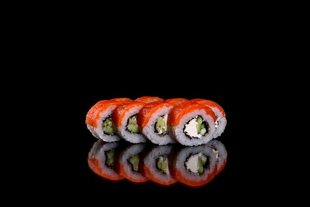 Fresh delicious sushi rolls on a dark background