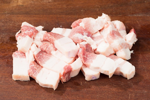 Fresh diced pork belly on chopping board