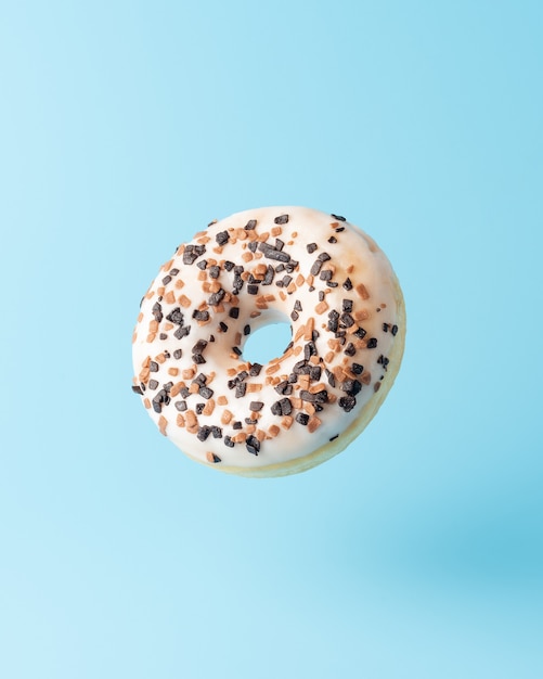 Fresh donut on blue background.