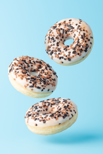 Fresh donuts on blue background.