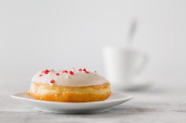 Fresh donuts on tray тв cup of hot espresso