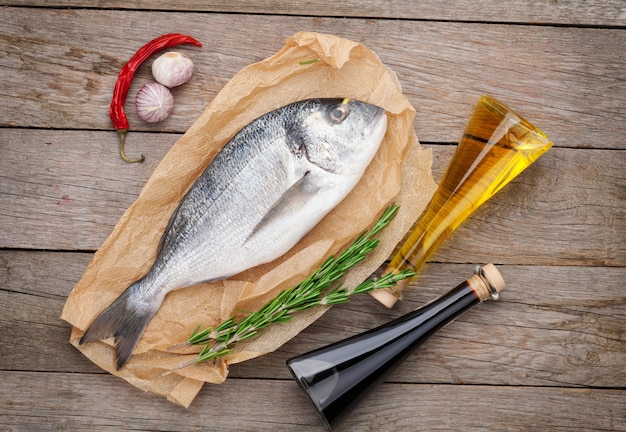 Fresh dorado fish cooking with spices and condiments