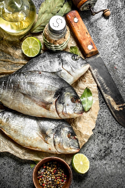 Fresh Dorado fish with an old knife and spices.