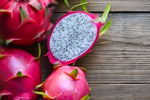 Fresh dragon fruit tropical in the asian thailand healthy fruit concept dragon fruit cut half on wooden with pitahaya background