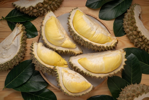 Fresh Durian fruit on black plate Durian fruit with peel the King of fruits on wooden background