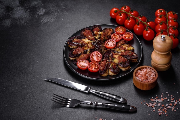 Fresh eggplant baked with minced meat spices and herbs on a black plate