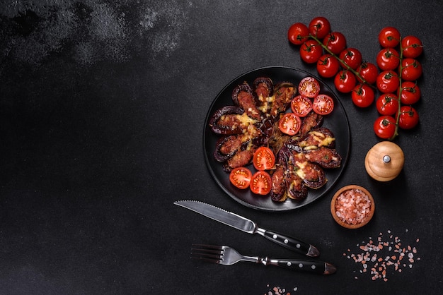 Fresh eggplant baked with minced meat spices and herbs on a black plate