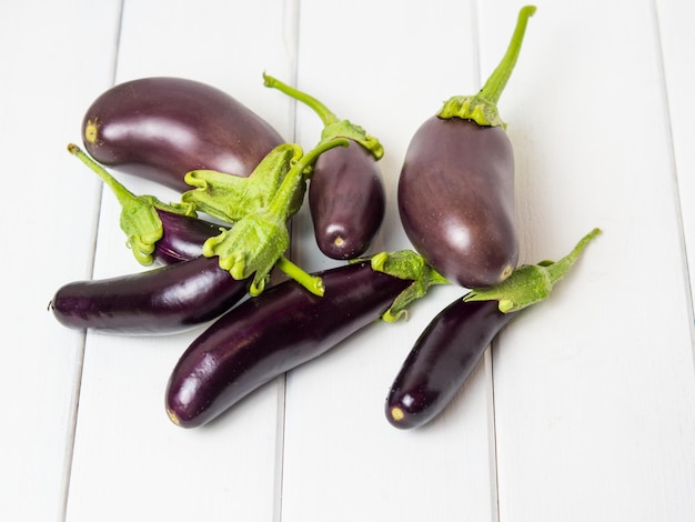 Fresh eggplant on a wooden background closeup