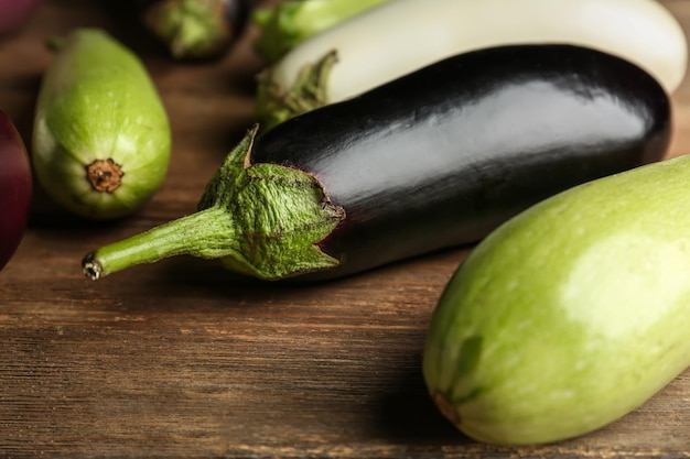 Fresh eggplants on wooden background