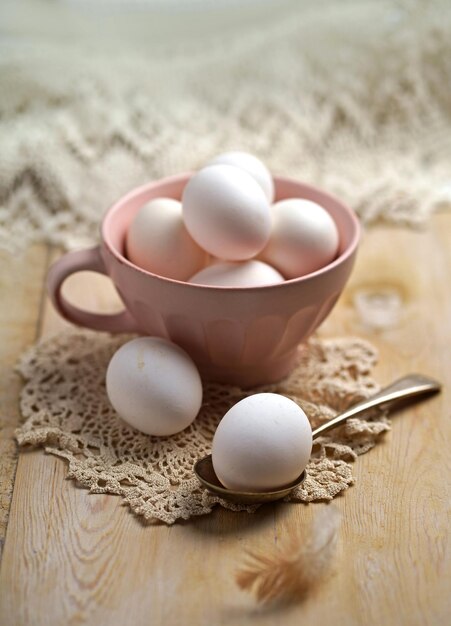 Fresh eggs from the farm placed on a white wooden table background