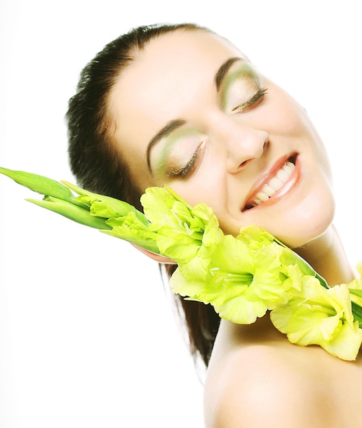 Fresh face with gladiolus flowers in her hands