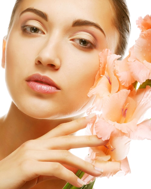 Fresh face with gladiolus flowers in her hands