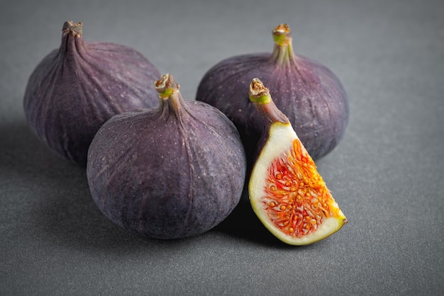 Fresh figs on grey background Beautiful blue violet fruit close up