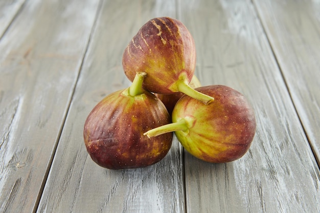 Fresh figs stacked in bunch on wooden background