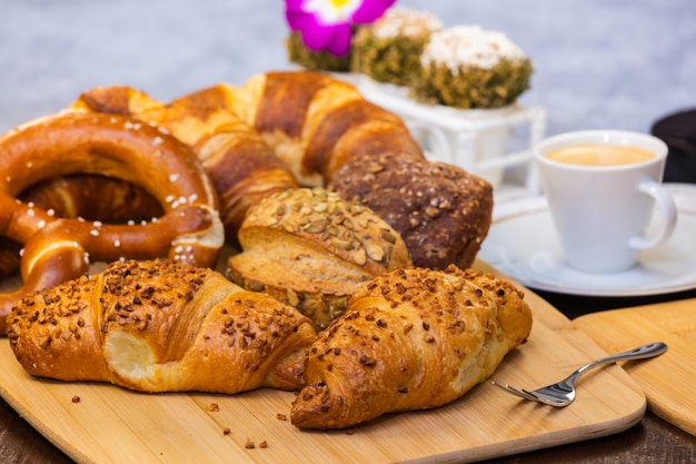 Fresh fragrant bread with and coffee beautiful flower is a good breakfast for the body on the table.