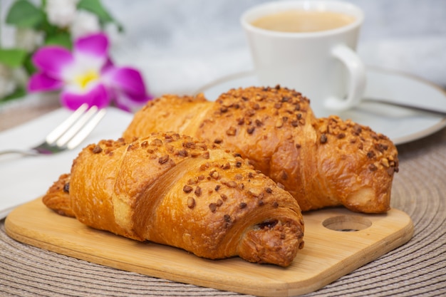 Fresh fragrant bread with and coffee beautiful flower is a good breakfast for the body on the table.