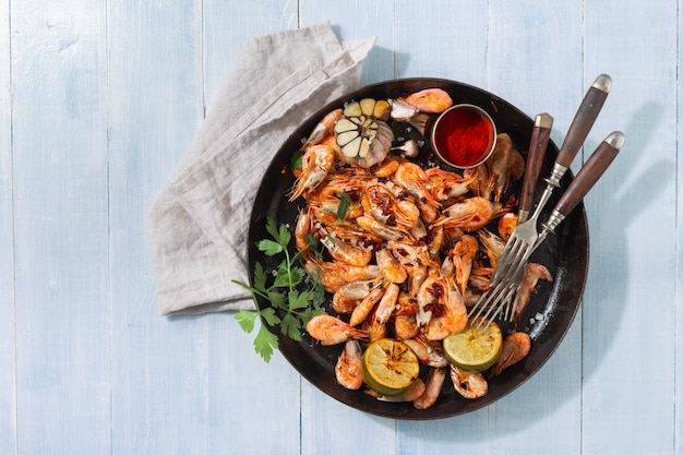 Fresh fried prawns on a blue wooden top view