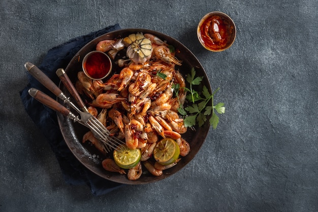 Fresh fried spiced shrimp in a frying pan top view