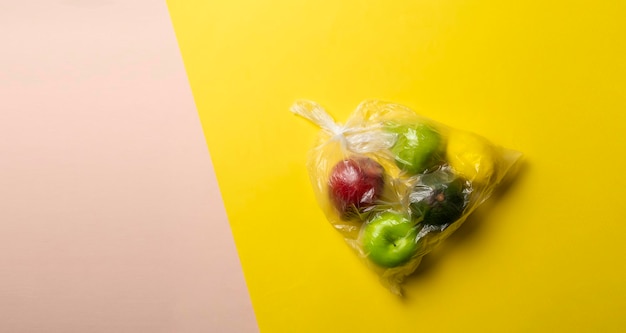 A fresh fruit food in the plastic bag package apple orange banana avocado