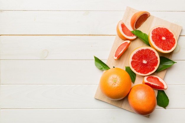 Fresh Fruit grapefruit slices on colored background Top view Copy Space creative summer concept Half of citrus in minimal flat lay with copy space