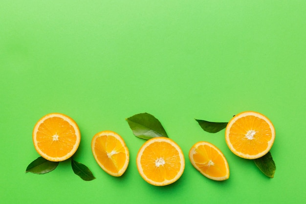 Fresh Fruit orange slices on colored background Top view Copy Space creative summer concept Half of citrus in minimal flat lay with copy space