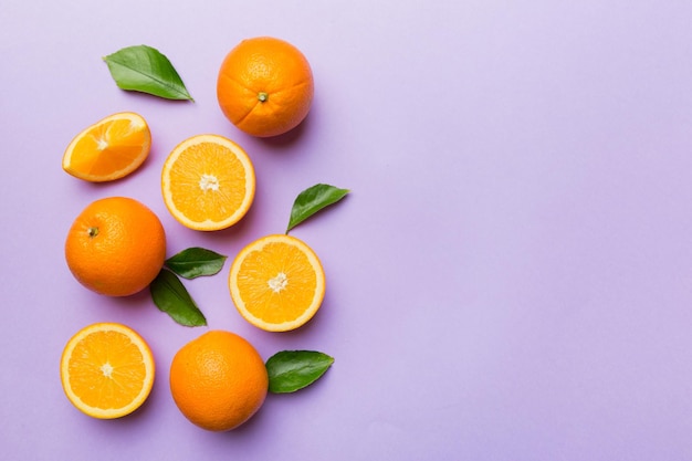 Fresh Fruit orange slices on colored background Top view Copy Space creative summer concept Half of citrus in minimal flat lay with copy space