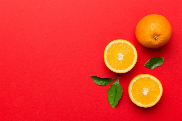 Fresh Fruit orange slices on colored background Top view Copy Space creative summer concept Half of citrus in minimal flat lay with copy space