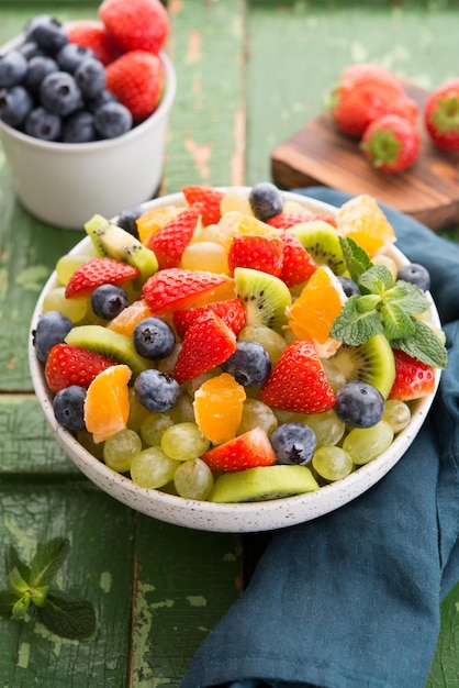 Fresh fruit salad, blueberries, strawberries, grapes, kiwi, orange. Selective focus